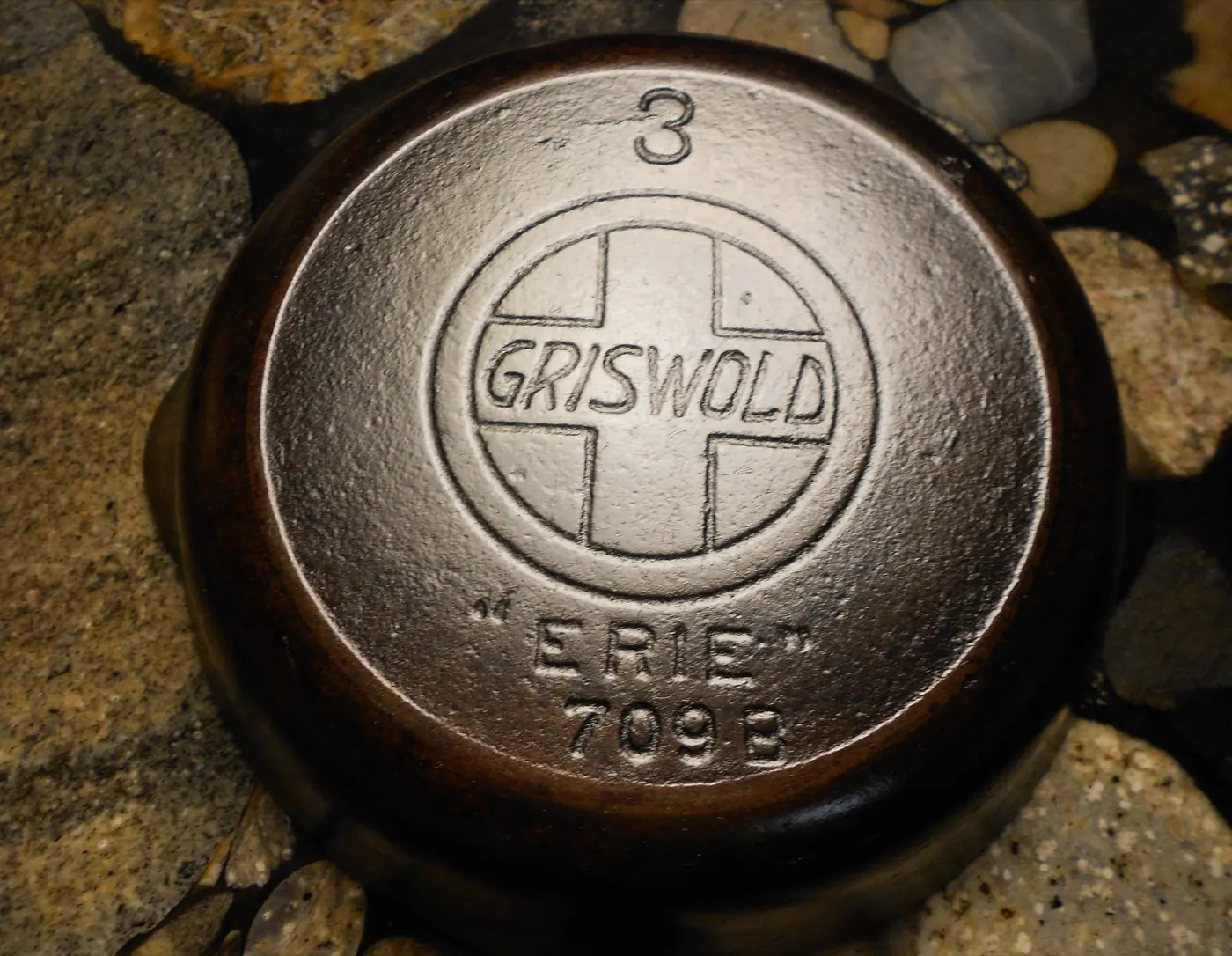 Underside of a Griswold No. 3 cast iron skillet showing its Griswold, ERIE, and 709 markings.